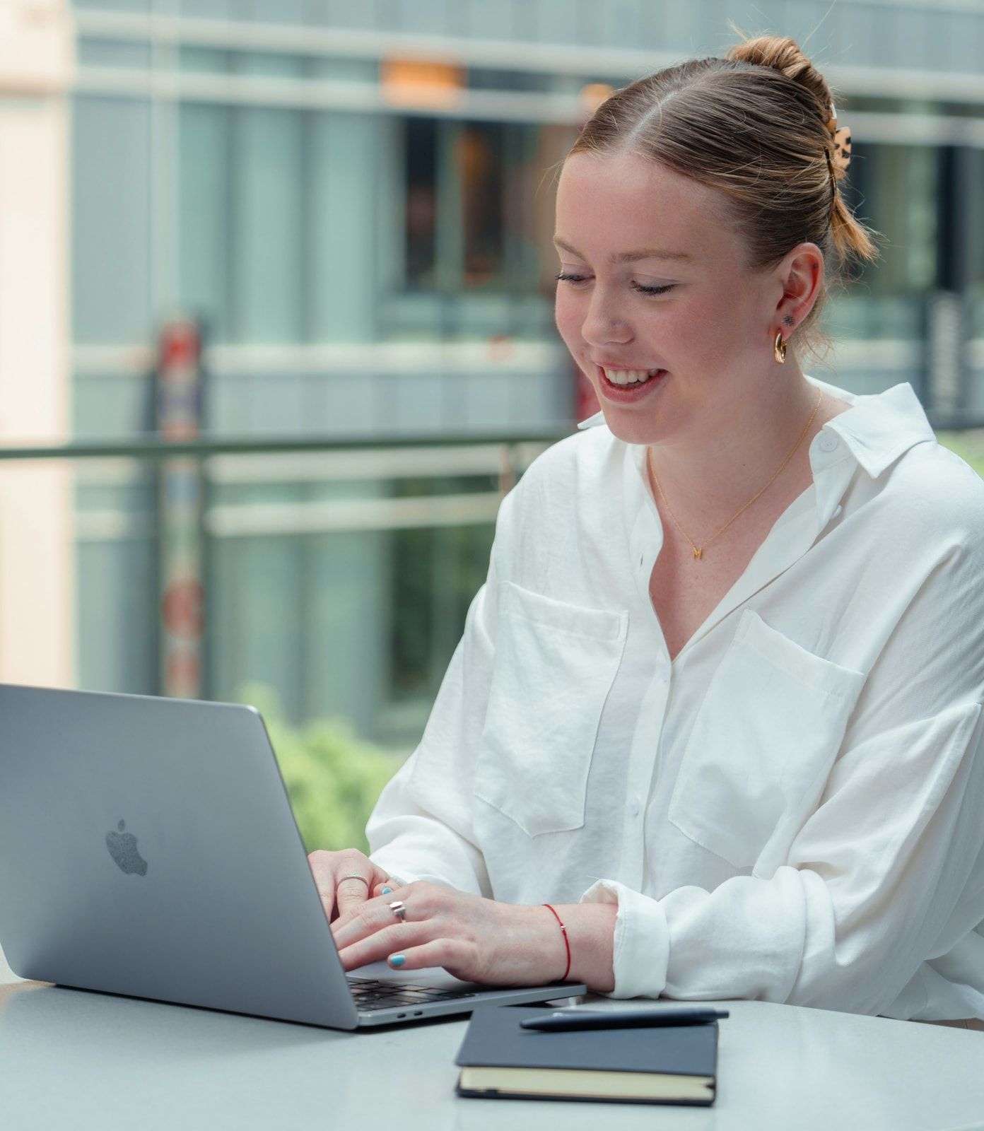 A learner smiling at her laptop during a live CADI training session